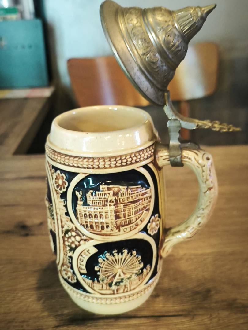 Ceramic beer mug with a metal lid