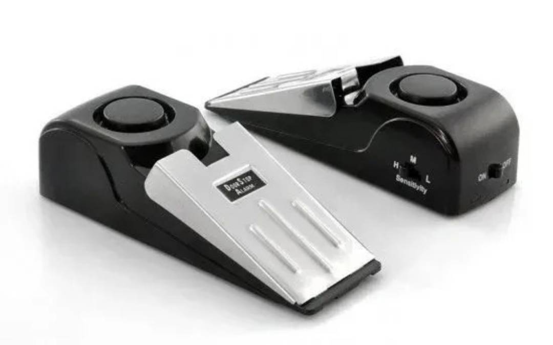 Portable wedge-shaped door alarm with adjustable sensitivity